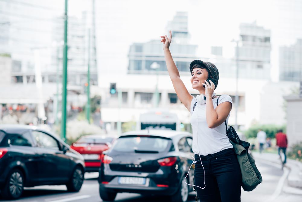girl-looking-for-a-car-uber-ride-taxi-phone-smile girl-looking-for-a-car-uber-ride-taxi-phone-smile